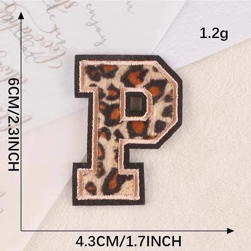 A leopard print iron-on patch shaped like the letter P, measuring 6cm high and 4.3cm wide.