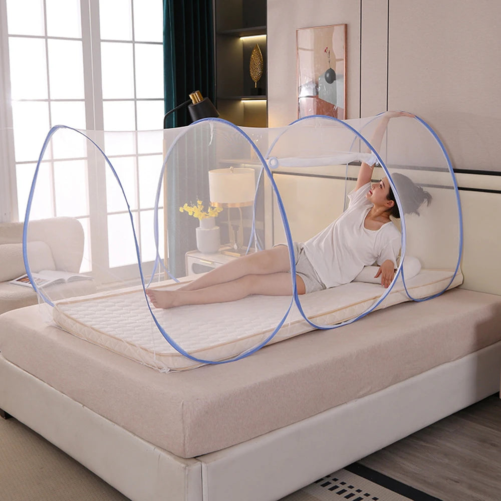 A person is relaxing on a bed while surrounded by large, transparent mosquito netting circles.