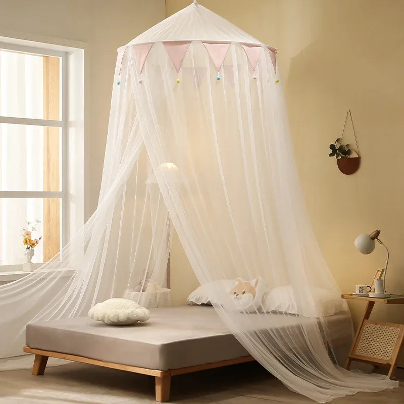 A sheer white mosquito net canopy is draped over a bed, providing a protective enclosure.