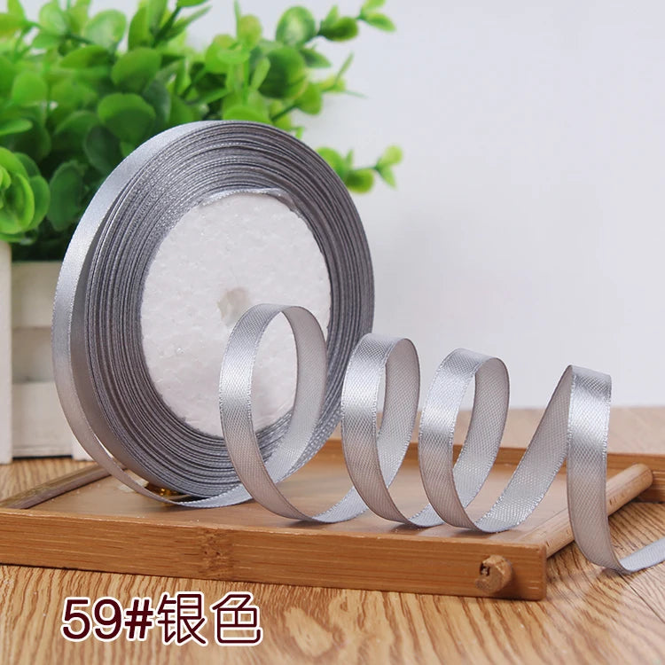 Roll of silver satin ribbon for crafting and decoration