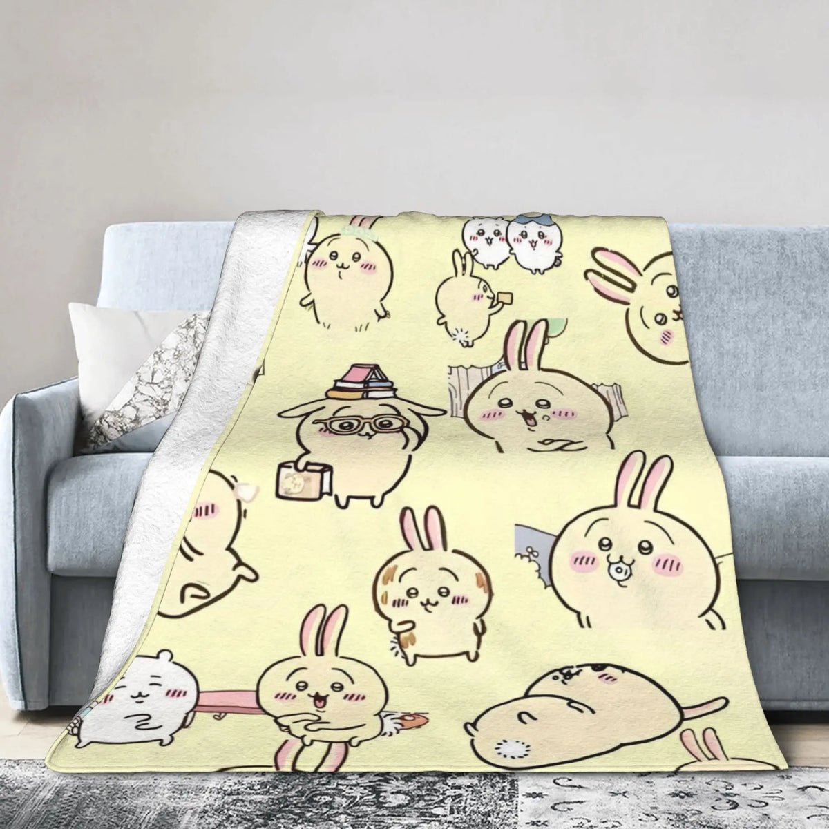 A yellow flannel throw blanket featuring a repeating pattern of cute Chiikawa cartoon rabbits.