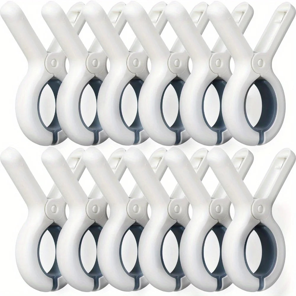 A set of white heavy-duty plastic clothespins with rust-resistant springs arranged in a row.