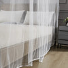 A sheer white mosquito net draped over a bed in a bedroom setting.