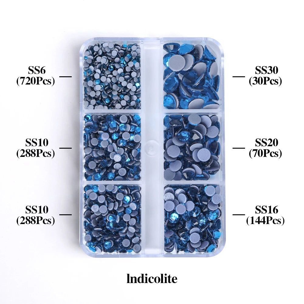 A clear plastic container holds various sizes of blue iridescent glass rhinestones categorized by SS6, SS10, SS16, SS20, and 