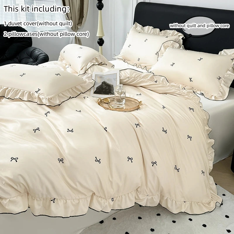 A set of beige Korean lace duvet covers, pillows, and a matching duvet cover displayed on a bed.