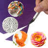 A set of craft accessories including a lion head, a floral pattern, a rooster, and a colorful flower, displayed on purple fab