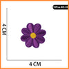 A set of 10 purple and yellow embroidered flower patches for iron-on use.