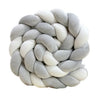 Handmade knotted floor mat for bed decor made of gray and white fluffy yarn.