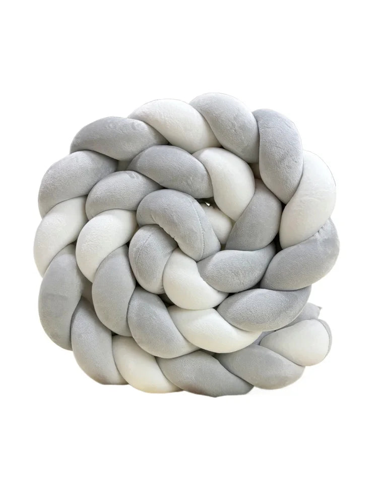 Handmade knotted floor mat for bed decor made of gray and white fluffy yarn.