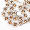 Close-up of sunflower crystal rhinestone sew-on buttons in gold and silver tones.