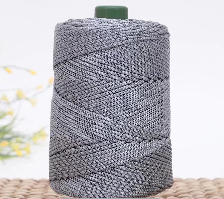 Gray crochet ice rope wound tightly on a spool with a green cap.