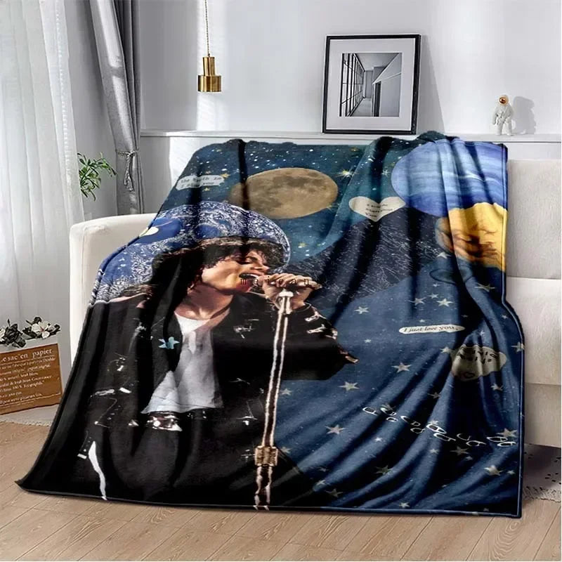 A dark blue and black printed flannel blanket featuring a musician playing an electric guitar.