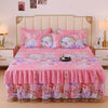 Pink floral bed skirt with lace trim protecting a mattress, set against a light pink headboard.