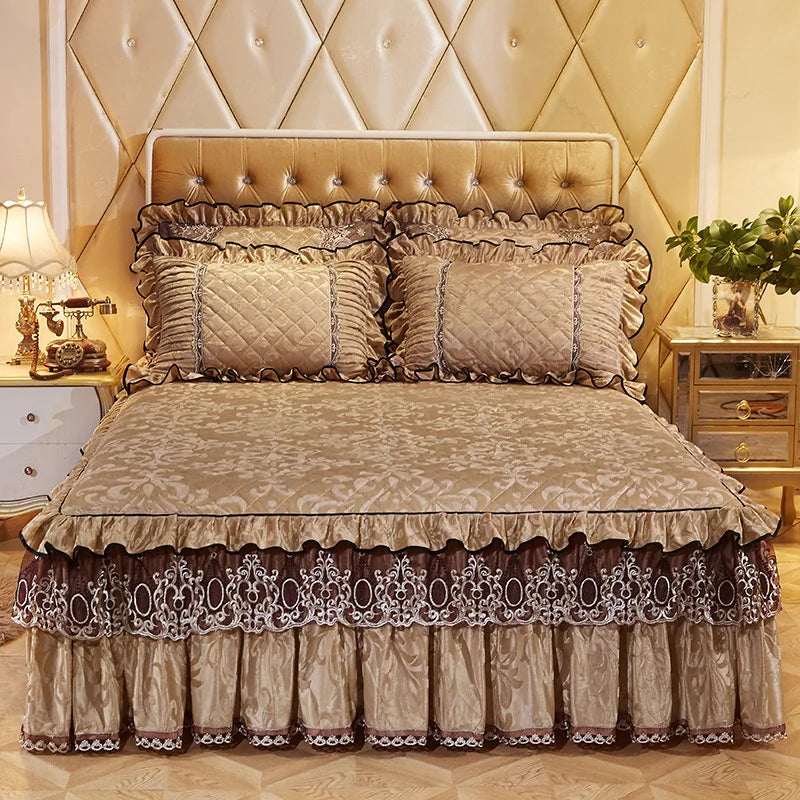 A luxurious bed set featuring a beige quilted bed skirt, pillowcases, and a tufted headboard.