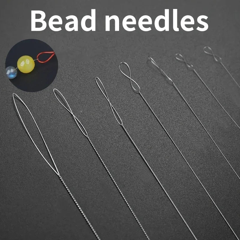 A set of stainless steel bead needles for jewelry making displayed on a dark surface.