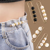 A close-up of an adjustable pearl brooch worn on a denim shirt pocket and displayed separately.