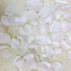 A close-up view of a pack of white and pink silk rose petals for weddings and events.