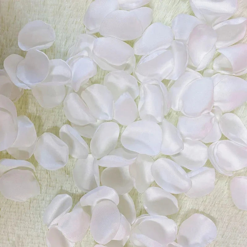 A close-up view of a pack of white and pink silk rose petals for weddings and events.