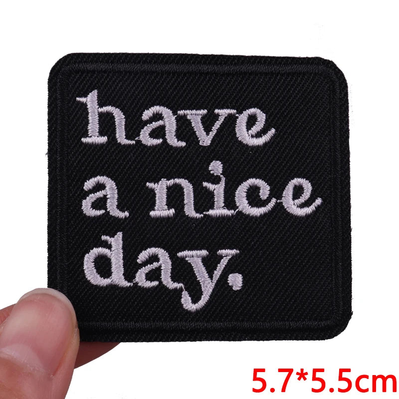 Black embroidered patch with white text that reads have a nice day
