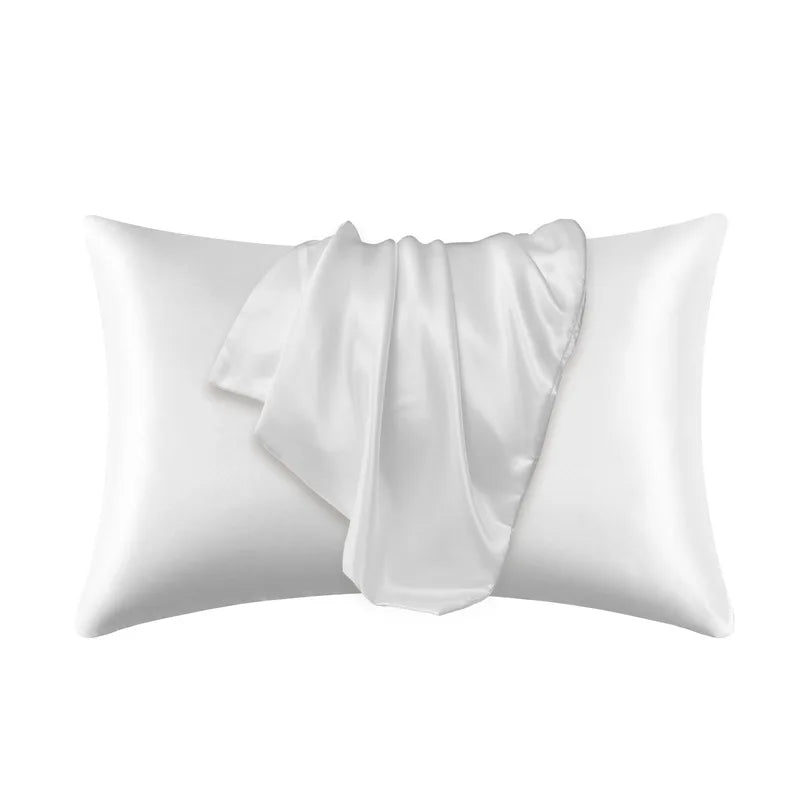 White satin silk pillow covers folded and displayed