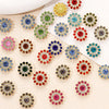 A collection of multicolor sew-on rhinestone crystals in various shapes and sizes scattered on a light background.