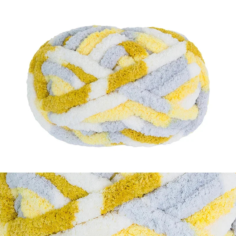 A ball of hand-knitted wool finger line scarf featuring yellow and gray stripes.