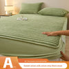A rabbit velvet milk velvet strip fitted sheet in light green color shown on a bed.