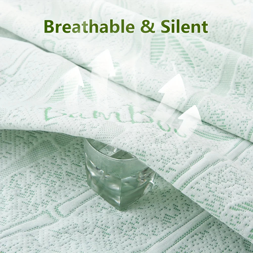 A close-up of a white bamboo fiber fitted sheet draped over a green surface, with a glass resting on the fabric.