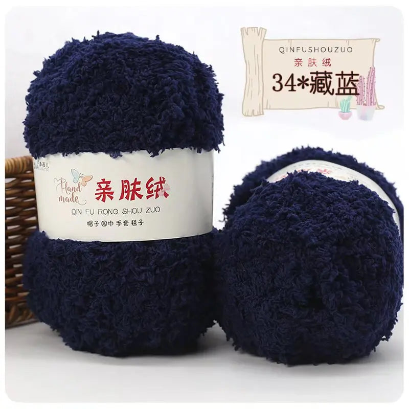 A ball of dark blue fuzzy yarn labeled as Plant Made Soft Coral Velvet Yarn for crafting.