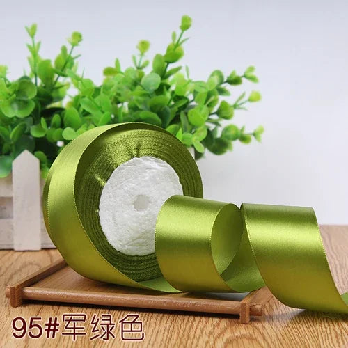 Roll of 4 cm wide satin ribbon in olive green color for gift wrapping and DIY crafts