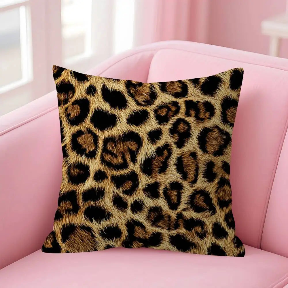 A square decorative pillow cover with a leopard print fabric resting on a pink sofa.