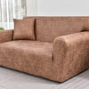 A modern, brown PU leather sofa slipcover in a living room setting.
