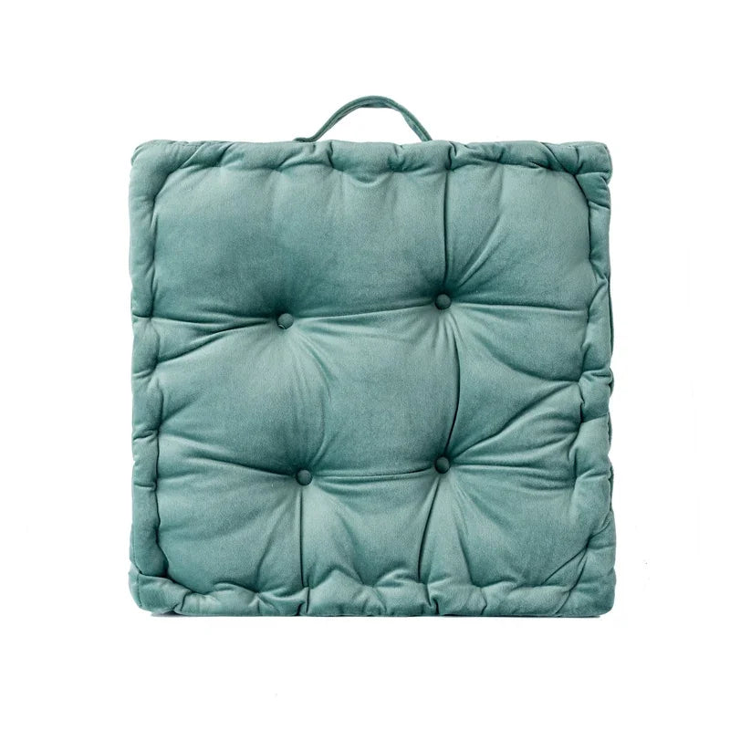A square teal cotton throw pillow with a quilted texture.