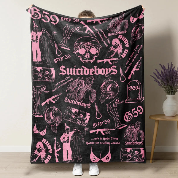 A black blanket featuring pink and white retro punk style skulls, guns, and text like Suicideboys and grep 59.