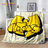 A yellow and black graphic design blanket featuring a stylized cat head on a light patterned background.