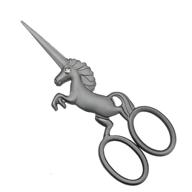 A silver unicorn-themed sewing scissors with a pointed horn and decorative handle.
