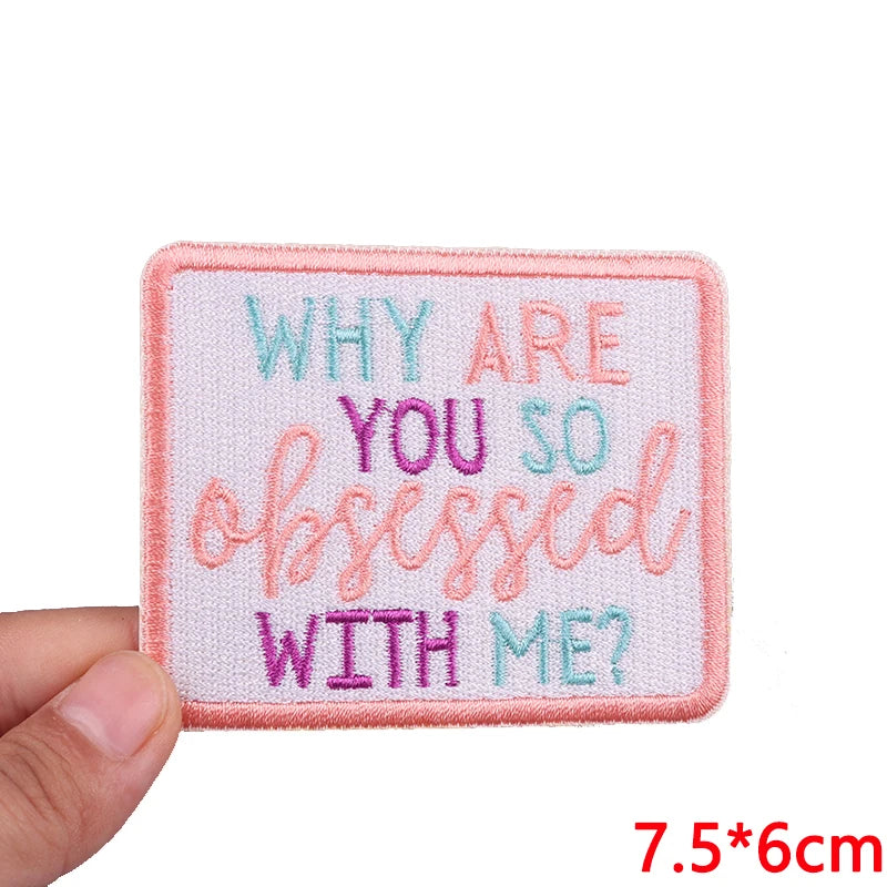 Pink embroidered patch with the text Why are you so obsessed with me