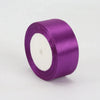 A roll of 4cm satin ribbon in vibrant purple for crafts and gift wrapping.
