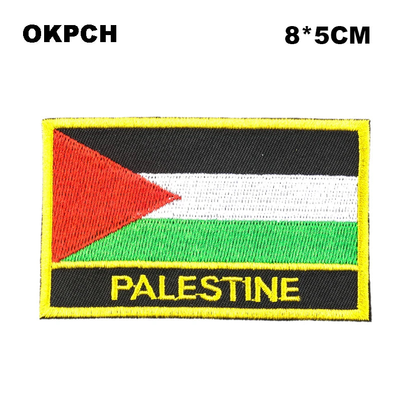 An embroidered patch featuring the flag of Palestine with black, white, and green stripes and a yellow border.