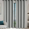 Gray blackout window curtains hanging in a doorway with black grommets.
