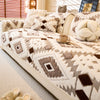 A beige sofa slipcover featuring a cream and brown geometric patterned fleece fabric.