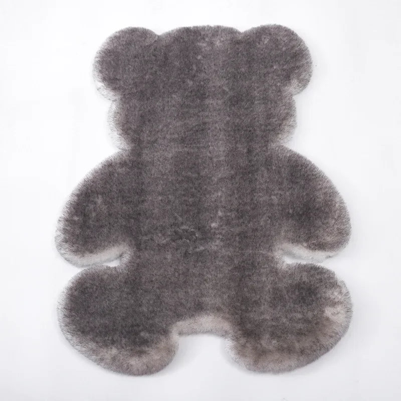 A gray plush bear-shaped non-slip area rug.