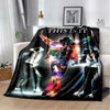 A black printed flannel blanket featuring a stylized graphic of a musician performing on stage.