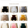 A collection of fourteen colors of plush bear-shaped non-slip area rugs displayed in various shades including black, white, g