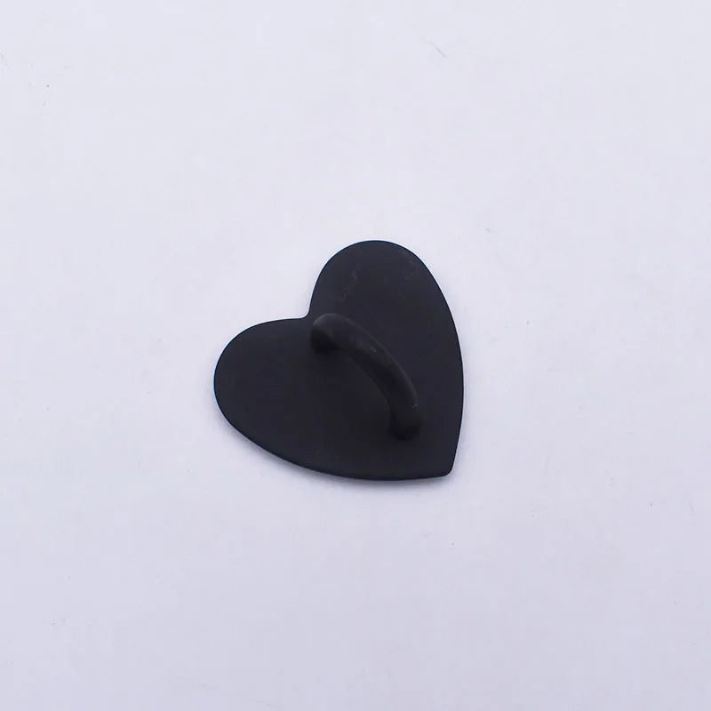 A small, black metal heart-shaped phone charm connector.