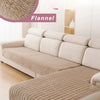 A beige flannel sofa cover on an L-shaped sectional sofa in a bright room.