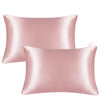 A pair of smooth, rosy pink mulberry silk satin pillowcases.