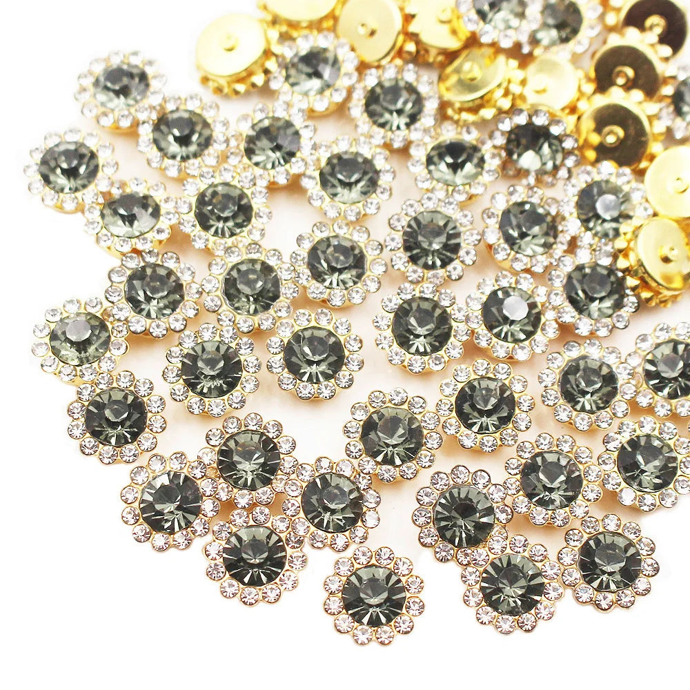A close-up of sunflower crystal rhinestone sew-on buttons in gold and clear tones.