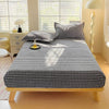 A black and white checkered flannel fitted sheet is laid out on a wooden bed frame.