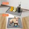 A silicone mat with rain gear pads and a pet mat placed on a wooden floor.